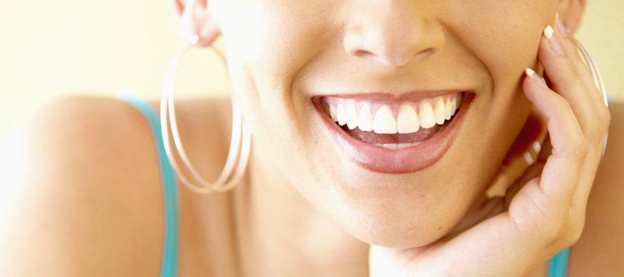 Portrait of a young woman smiling | DentalSave Blog