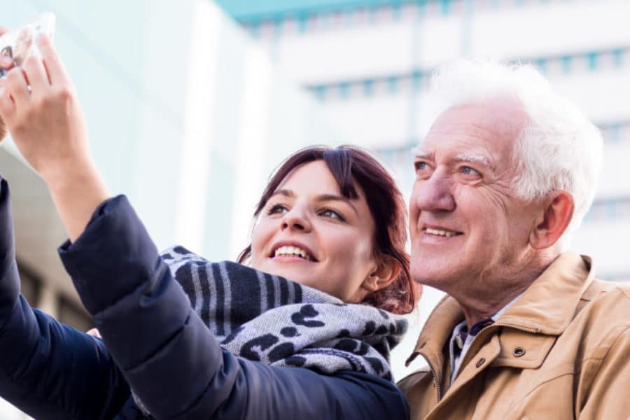 Mature father and daughter are taking selfie
