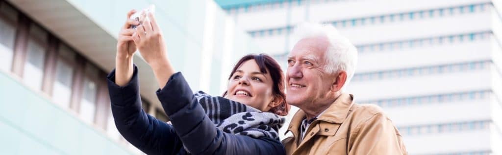Mature father and daughter are taking selfie