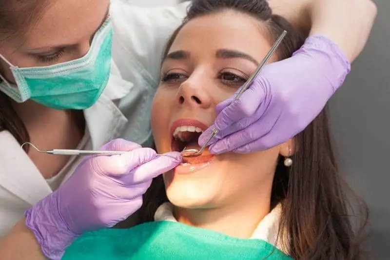 dental therapist examining a patient